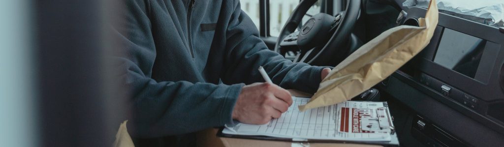 Person writing on Top of a Box